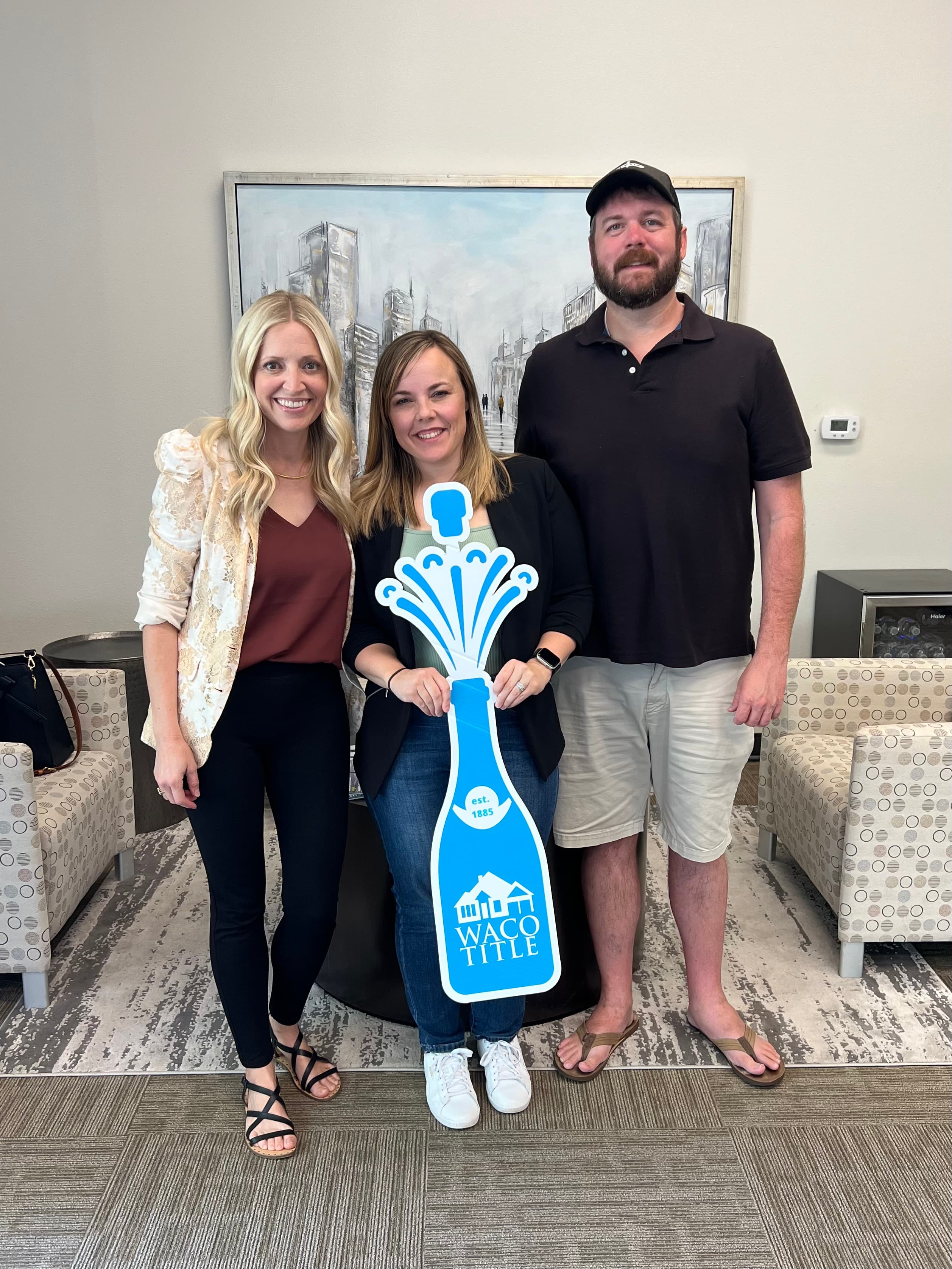 Jennifer Hooks with clients at a Waco Title closing