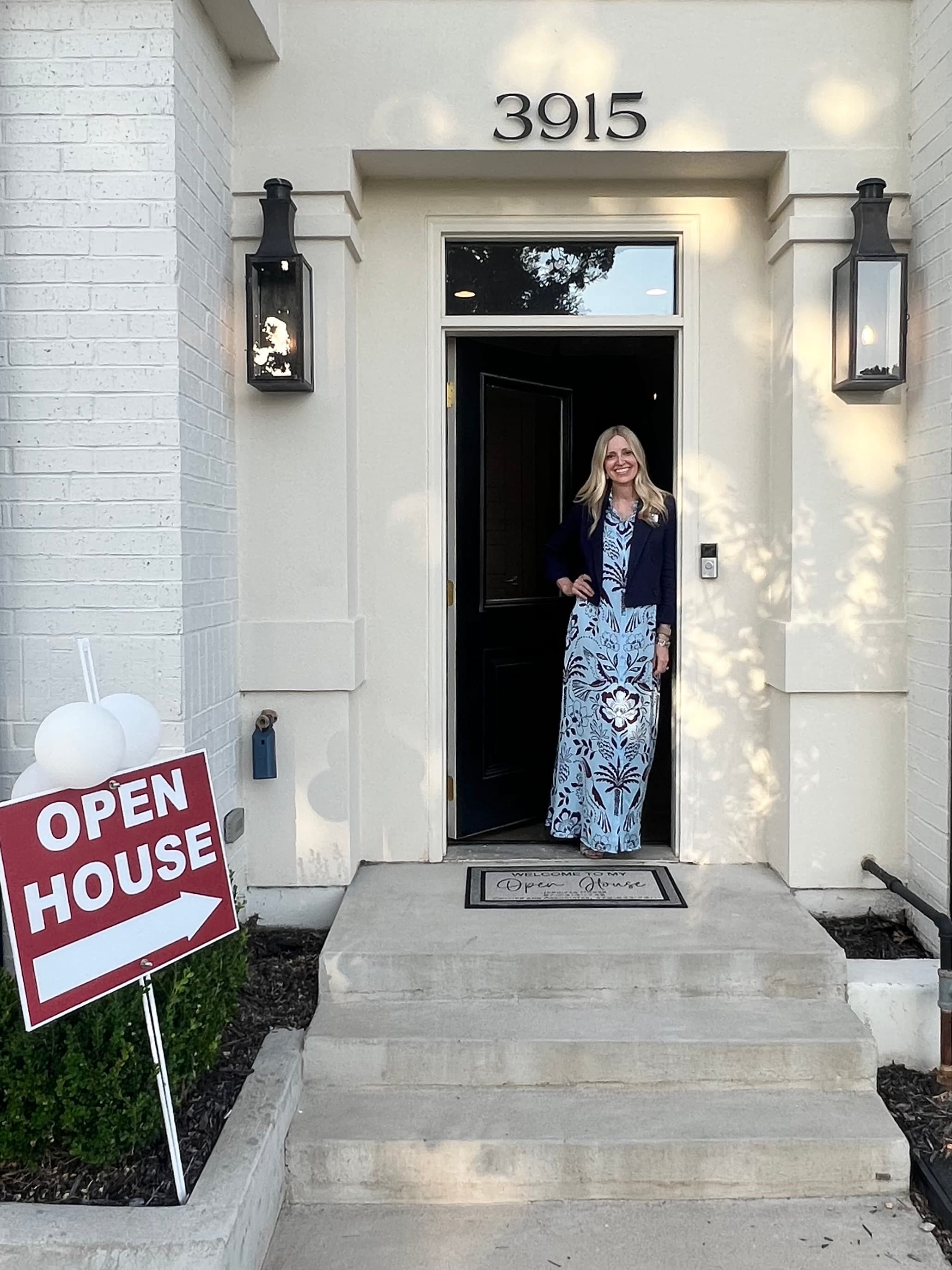 Jennifer Hooks welcoming visitors at an open house doorway