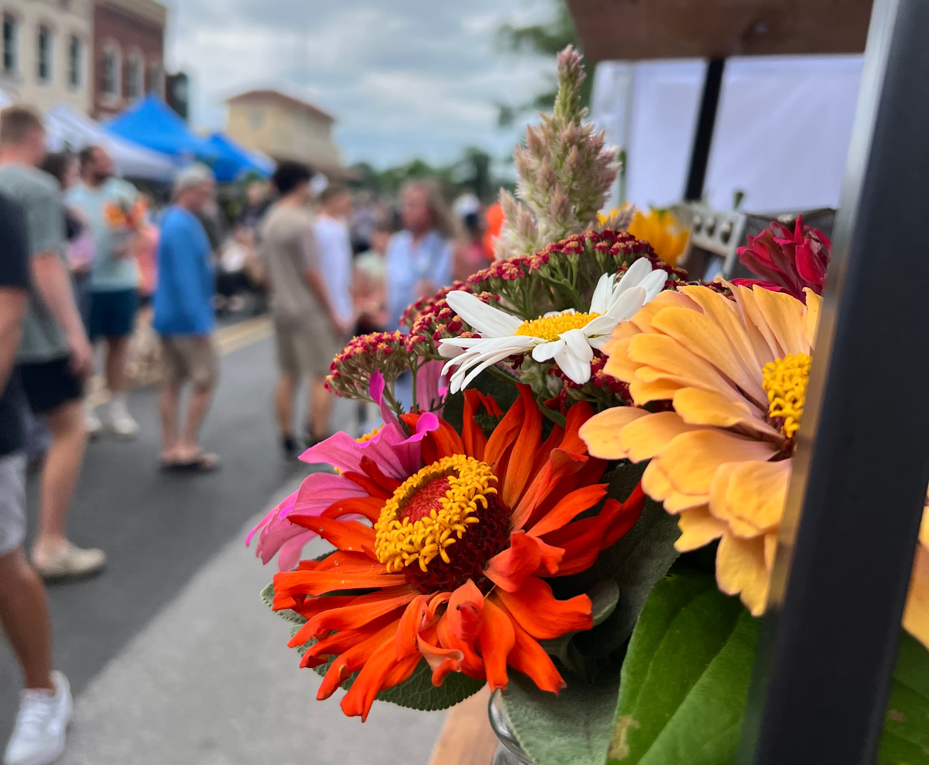 Farmers market flowers with a street scene in the background