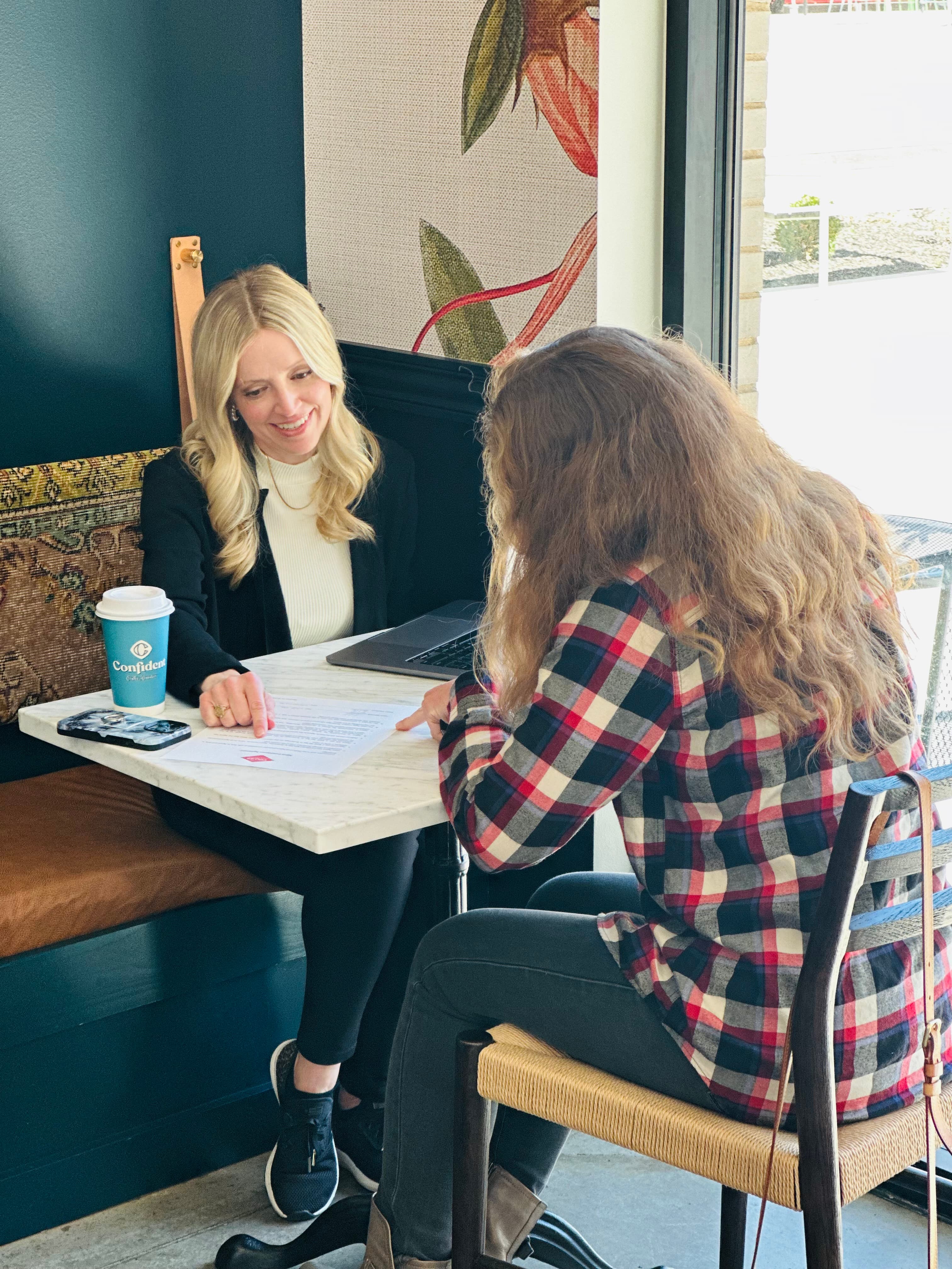 Jennifer Hooks meeting with a client in a coffee shop